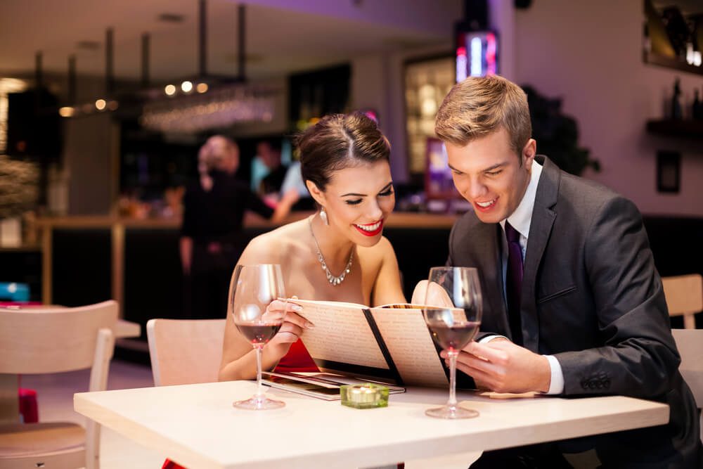 A couple enjoying dinner at a fine dining restaurant in Fredericksburg.