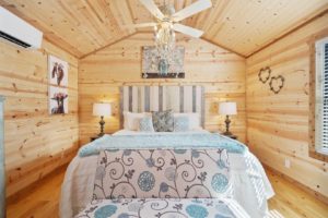 A cozy bedroom at a Fredericksburg vacation rental to relax in after exploring Main Street.