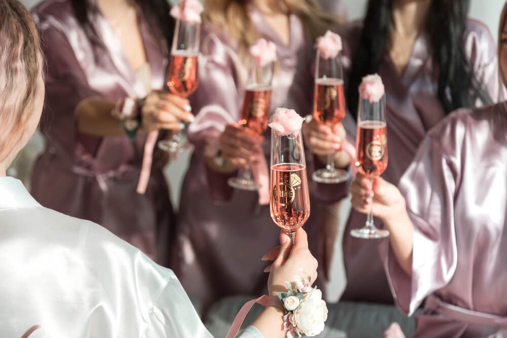 A group of women drinking champagne at a Texas bachelorette party.