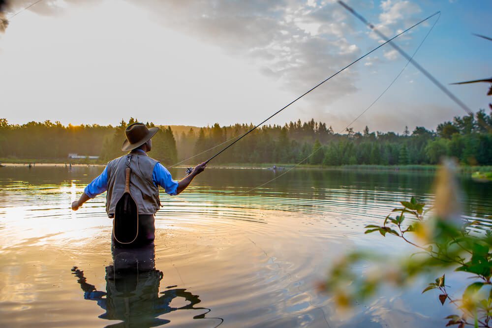 A man fly fishing, one of the many outdoor trips to enjoy in Fredericksburg, Texas