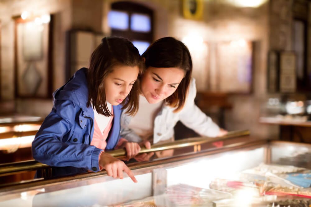 A mom and daughter looking at a display at one of the museums in Fredericksburg, TX.