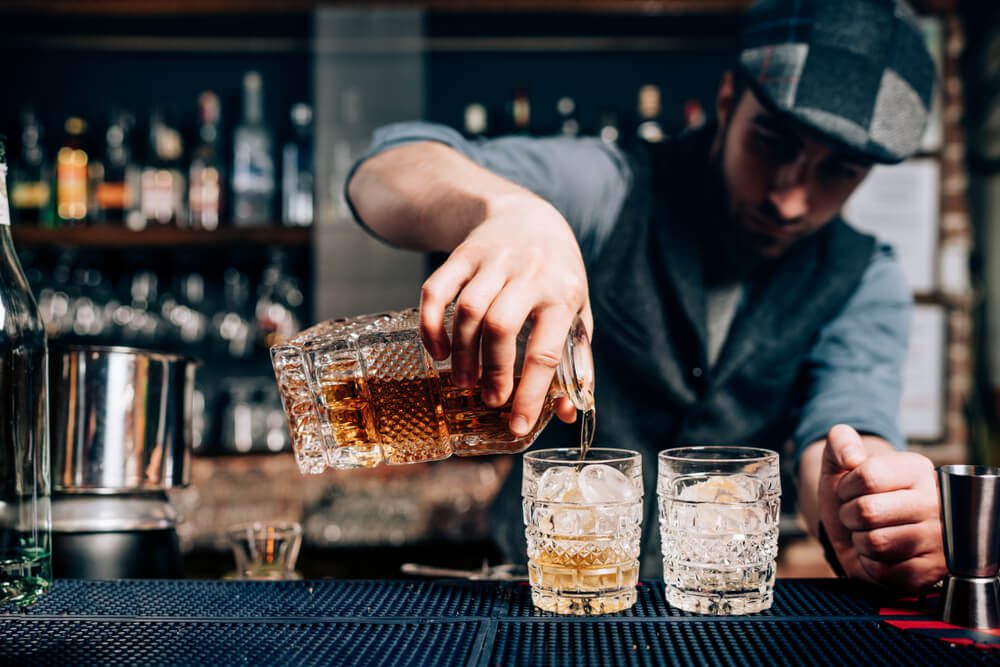 A bartender pouring a drink at a Fredericksburg distillery.