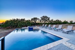A pool at a vacation rental in Fredericksburg, TX, to lounge by after visiting the spas.