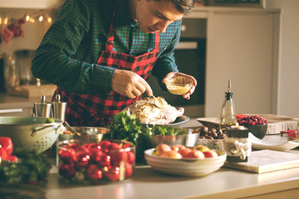 A man cooking a holiday meal in a Fredericksburg, TX, rental.